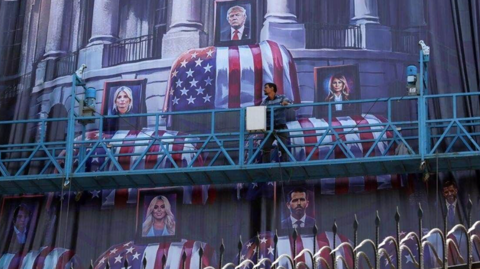 A billboard in Tehran depicted Donald Trump and members of his family above coffins bearing the American flag (@Daily_Express/X)